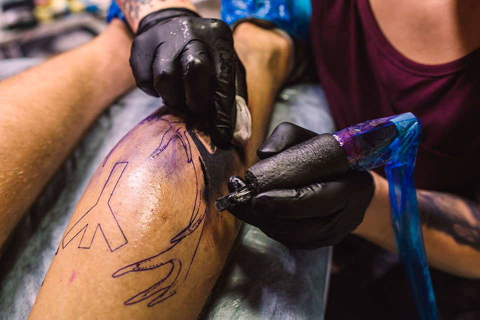 artist working in a tattoo shop