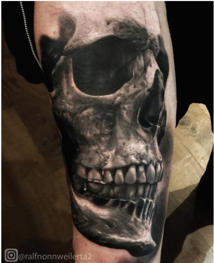 skull tattoo design on the human bodyos made with black ink