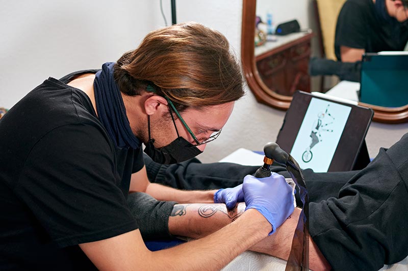 artist giving someone a tattoo