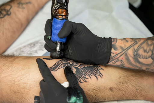 person getting tattooed in a tattoo shop