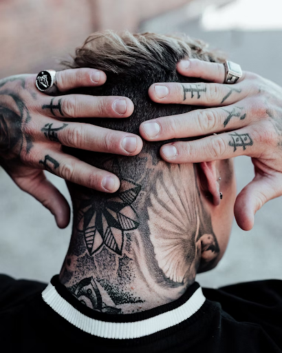 blackwork designs inked onto the back fo the neck