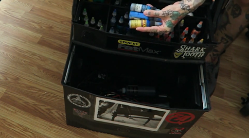 person holding tattoo ink