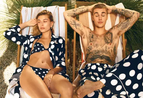 Justin and Hailey Bieber posing for a magazine with visible tattoos