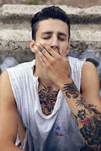 Model posing with tattoos visible