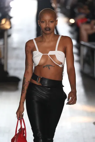 Model with tattoos on runway