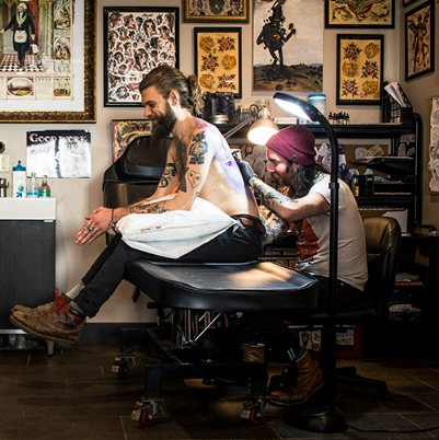 professional tattoo artist working in a tattoo studio