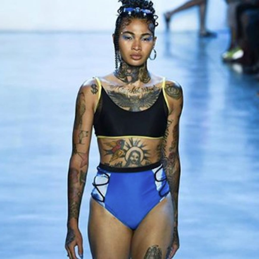 runway model with multiple visible tattoos