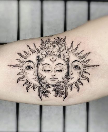sun body art design by tattoo artist in black ink