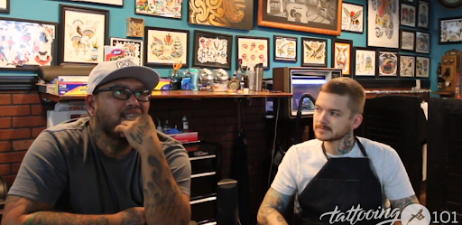 tattoo artist talking about techniques in a tattoo shop