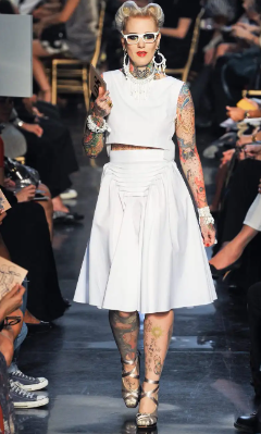 tattooed model walking runway