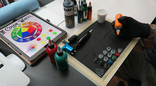 instructor showing tattooing tools