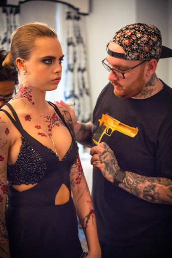 Tattoos being applied to Cara Delevigne for Met Gala